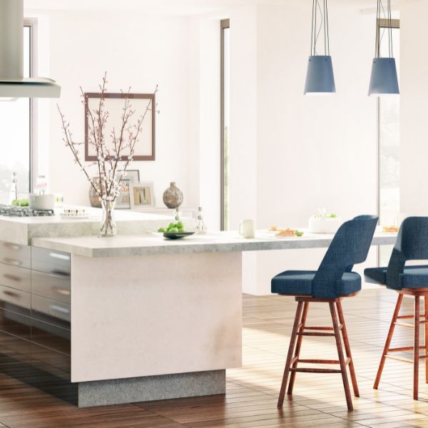 A clean and modern kitchen area with blue bar stools.