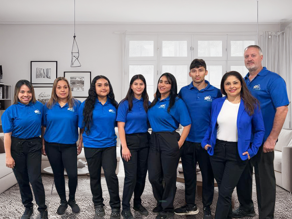 Professional cleaning team smiling together and ready to provide house cleaning services